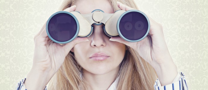 woman looking through binoculars