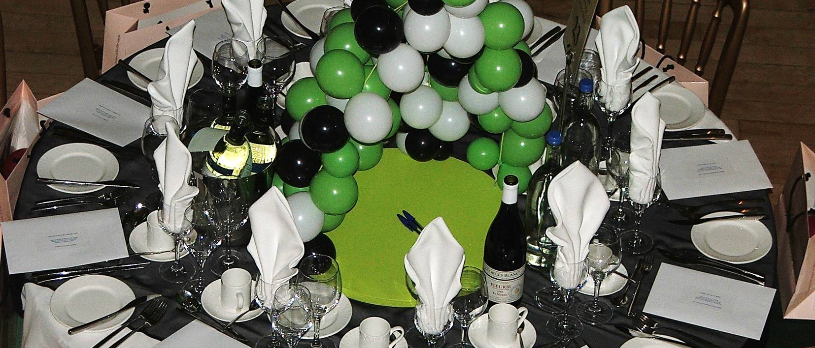 dinner table, balloons, wine, glasses plates, cutlery